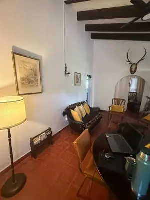 a living room with a couch and a table at Casa en La Falda, Córdoba in Cordoba