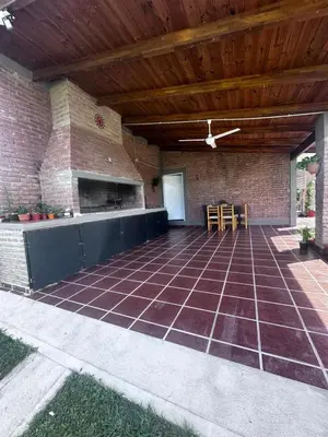 a patio with a brick wall and a wooden ceiling at RyC La Casita Mirador Del Lago in Villa Parque Siquiman