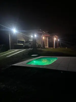 a green circle in the middle of a driveway at night at RyC La Casita Mirador Del Lago in Villa Parque Siquiman