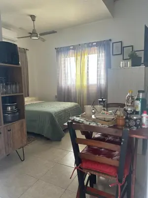 a room with a bed and a table with food on it at RyC La Casita Mirador Del Lago in Villa Parque Siquiman
