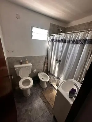 a bathroom with a toilet and a sink at RyC La Casita Mirador Del Lago in Villa Parque Siquiman