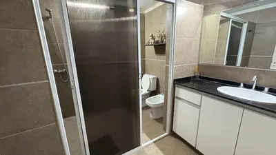 a bathroom with a shower and a sink and a toilet at Casa de campo, Dique Chico in Villa Anizacate