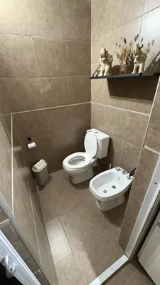 a bathroom with a toilet and a sink at Casa de campo, Dique Chico in Villa Anizacate