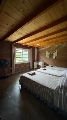a large bedroom with two beds in a room at Casa de campo, Dique Chico in Villa Anizacate