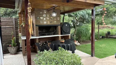 a patio with a table and an outdoor oven at Casa de campo, Dique Chico in Villa Anizacate