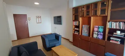 a living room with two blue chairs and a book shelf at Departamento Grande 3 Dormitorios con Cochera in Cordoba