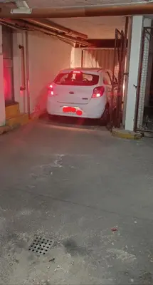 a white car is parked in a garage at Departamento Grande 3 Dormitorios con Cochera in Cordoba