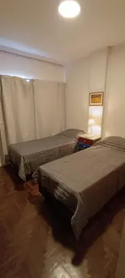a room with two beds in a room at Departamento Grande 3 Dormitorios con Cochera in Cordoba