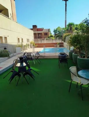 a group of tables and chairs on a green lawn at Lo de Lili in Cordoba