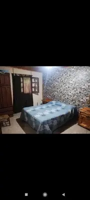 a bed in a room with a stone wall at Green mile in San Roque