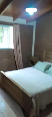 a bedroom with a large bed with a window at Cabañas de Ensueño in Cuesta Blanca