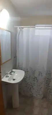 a bathroom with a sink and a shower curtain at Cabañas de Ensueño in Cuesta Blanca