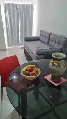a living room with a glass table with a bowl of fruit at Romina Cañada in Cordoba