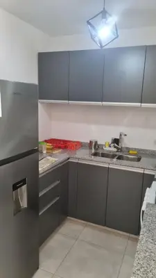 a kitchen with gray cabinets and a sink at Romina Cañada in Cordoba