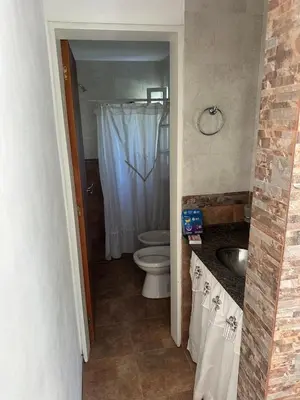 a bathroom with a toilet and a sink at Cabaña La Estancia in Villa Carlos Paz