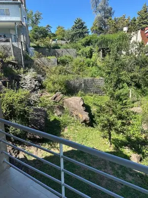 a view of a hill with a fence at Cabaña La Estancia in Villa Carlos Paz