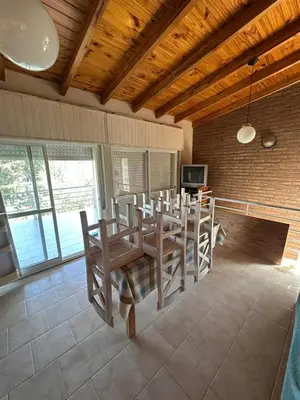 a dining room with a table and chairs at Cabaña La Estancia in Villa Carlos Paz