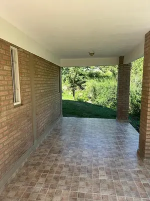 an empty room with a brick wall and a patio at Cabaña La Estancia in Villa Carlos Paz
