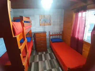 a bedroom with two bunk beds and a desk at Mi sueño en la naturaleza in Potrero de Garay