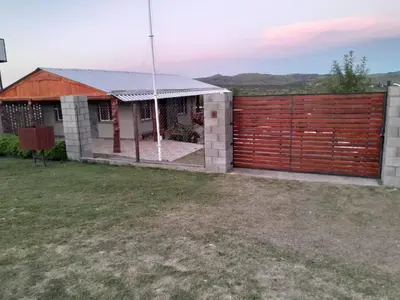 a house with a red fence and a yard at Mi sueño en la naturaleza in Potrero de Garay