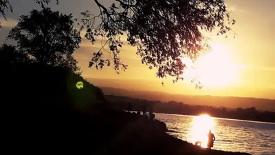 a sunset over a body of water with the sun setting at Cabaña La Pasionaria in Villa Quillinzo
