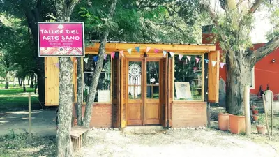a small building with a sign in front of it at Cabaña La Pasionaria in Villa Quillinzo