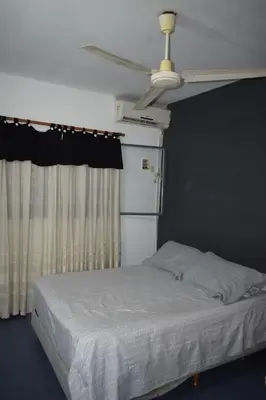 a bedroom with a bed and a ceiling fan at Casa Santa Lucía in Bialet Massé