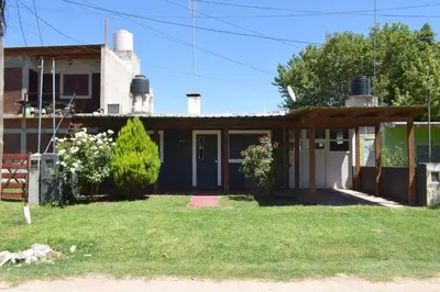 a house with a porch and a yard at Casa Santa Lucía in Bialet Massé