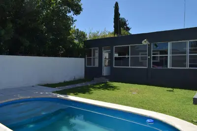 a swimming pool in front of a house at Casa Santa Lucía in Bialet Massé