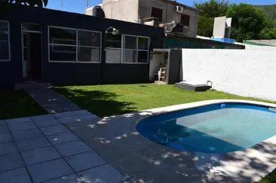 an empty swimming pool in the yard of a house at Casa Santa Lucía in Bialet Massé
