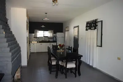 a dining room and kitchen with a table and chairs at Casa Santa Lucía in Bialet Massé