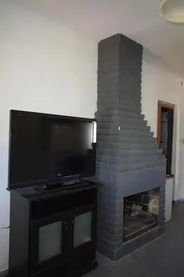 a living room with a fireplace with a flat screen tv at Casa Santa Lucía in Bialet Massé