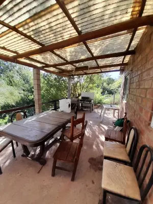 a picnic table and chairs on a patio at La Loma in Villa del Dique