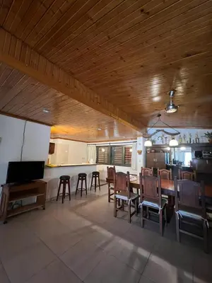 a kitchen and dining room with a table and chairs at Casa Edison in Villa Carlos Paz