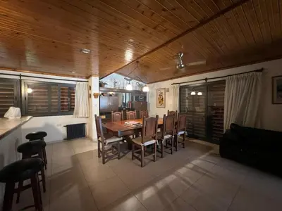 a kitchen and dining room with a table and chairs at Casa Edison in Villa Carlos Paz