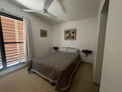 a bedroom with a bed and a ceiling fan at Casa Edison in Villa Carlos Paz