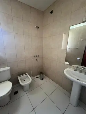 a bathroom with a toilet and a sink at Casa Edison in Villa Carlos Paz
