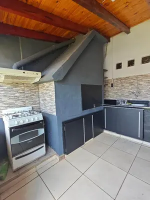 a kitchen with a stove and a sink at La Bernardina in Villa Carlos Paz