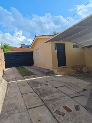 a house with a garage and a driveway at La Bernardina in Villa Carlos Paz