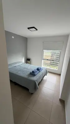 a bedroom with a bed and a large window at Apartment in Córdoba capital in Cordoba