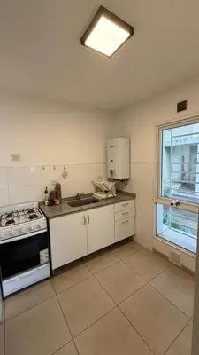 an empty kitchen with a stove and a window at Apartment in Córdoba capital in Cordoba