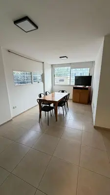 a room with a table and chairs and a tv at Apartment in Córdoba capital in Cordoba