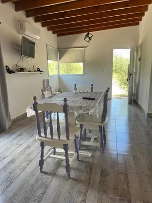 a dining room with a table and two chairs at La casita de Clau in Los Molles