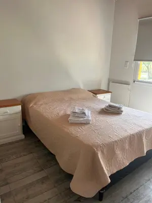 a bedroom with a bed with two towels on it at La casita de Clau in Los Molles