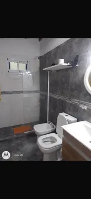 a bathroom with a toilet and a sink at La casita de Clau in Los Molles