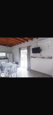 a room with a room with tables and a window at La casita de Clau in Los Molles
