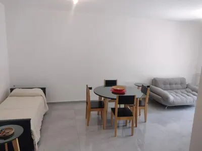 a living room with a table and a couch at Departamento céntrico a cuadras del lago san roque in Villa Carlos Paz