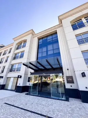 a building with a glass door in front of it at Apart France - Dos Dormitorios - Cochera, gim, piscina y spa in Río Cuarto