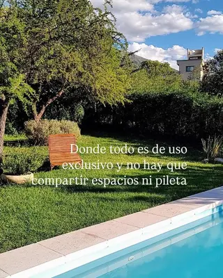 a sign for a park with a bench next to a pool at Casa Salvia in Los Hornillos