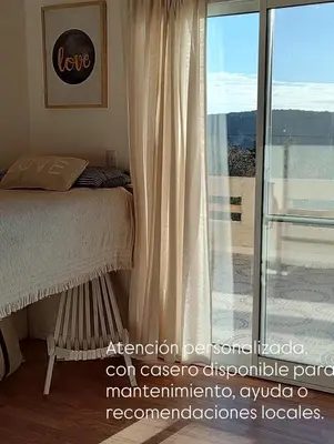 a bedroom with a bed and a sliding glass door at Casa Salvia in Los Hornillos